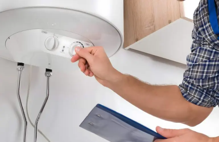 Technician checking a wall-mounted water heater